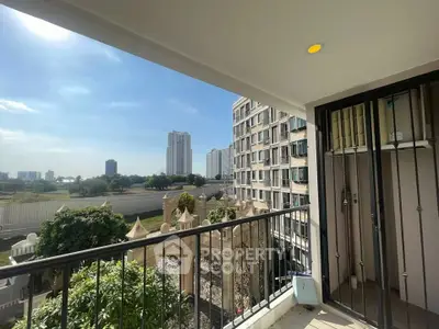 Spacious balcony with stunning city view in modern apartment complex