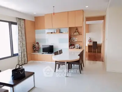 Modern living room with elegant dining area and built-in storage