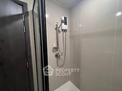 Modern bathroom with sleek shower design and neutral tiles