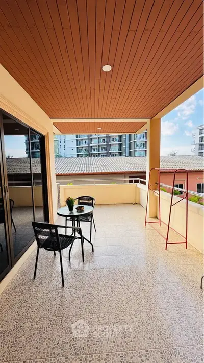 Spacious balcony with modern seating and city view, perfect for relaxation and entertaining.