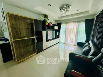 Modern living room with sleek furniture and large window for natural light.