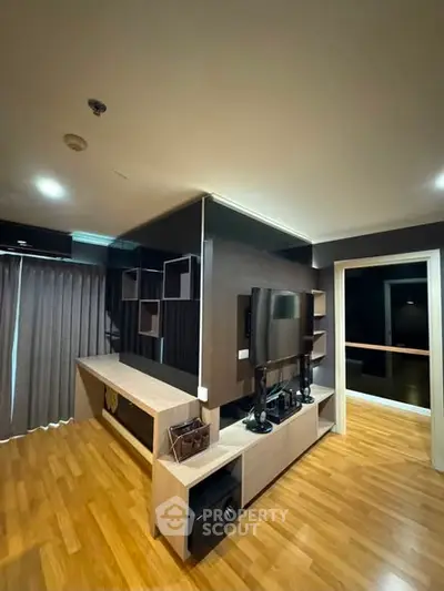 Modern living room with sleek wooden flooring and stylish TV unit