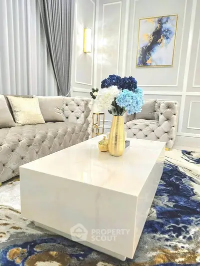 Luxurious living room with elegant decor, plush sofas, and a stylish coffee table.