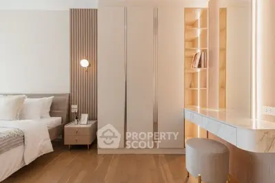 Elegant bedroom with modern decor, built-in wardrobe, and stylish lighting.