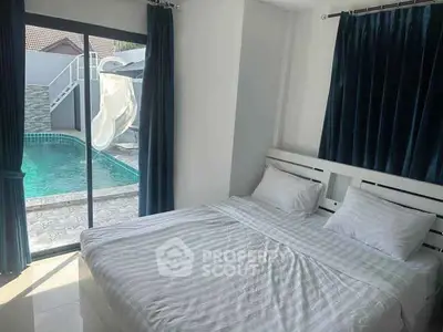 Cozy bedroom with pool view and sliding glass doors for easy access.