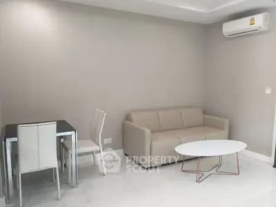 Modern living room with sleek furniture and air conditioning in a stylish apartment.