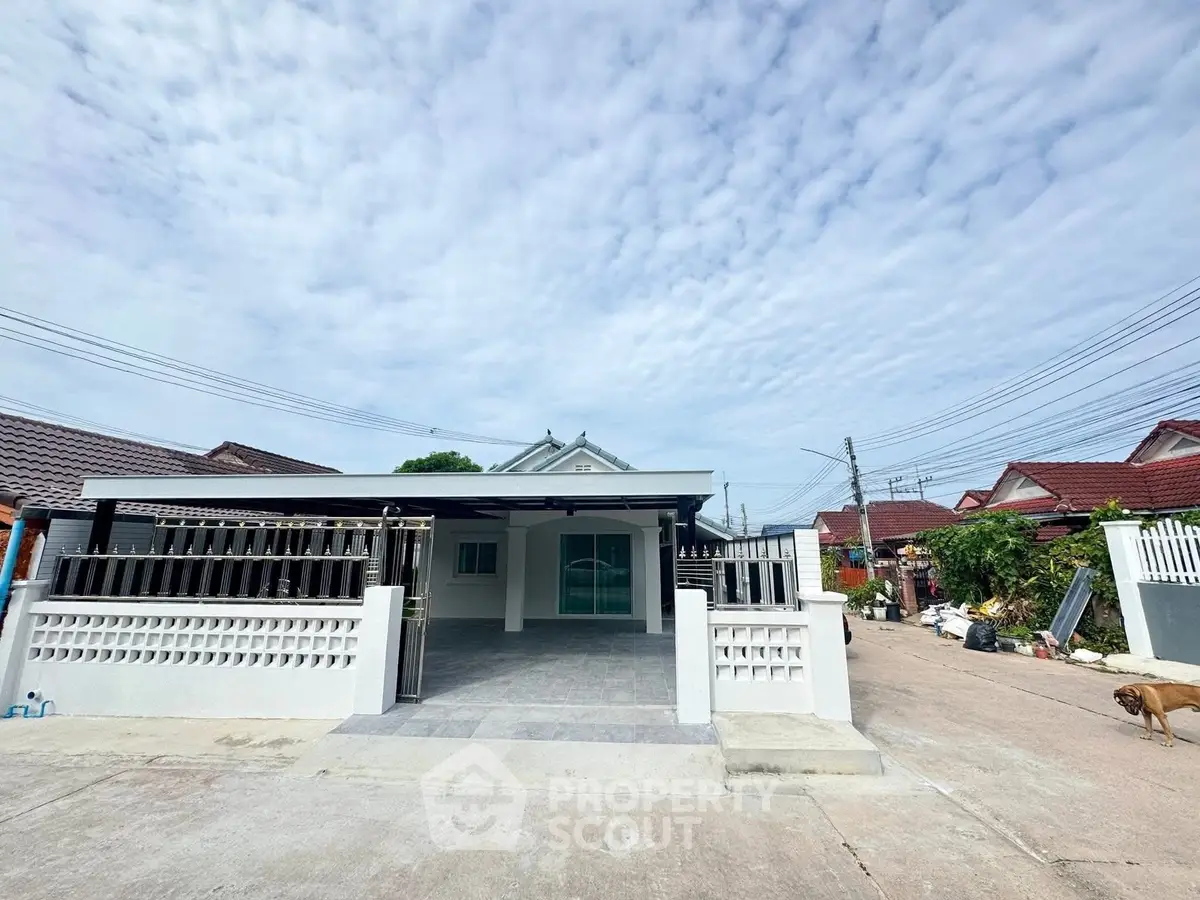 Charming single-story home with spacious driveway and modern exterior design.