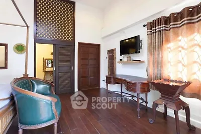 Charming vintage-style bedroom with wooden floors and classic furniture