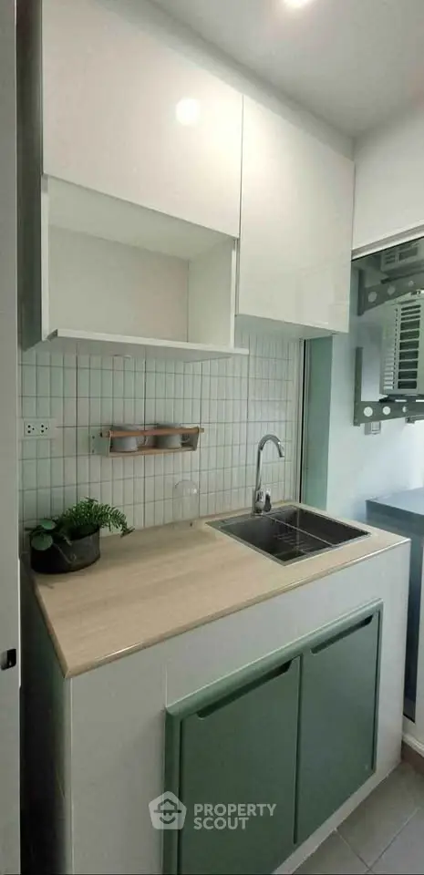 Modern compact kitchen with sleek cabinetry and stylish backsplash