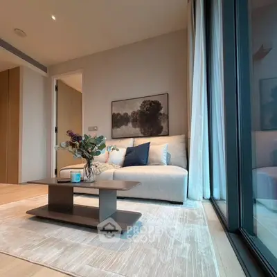 Elegant living room with modern decor and large windows offering natural light.