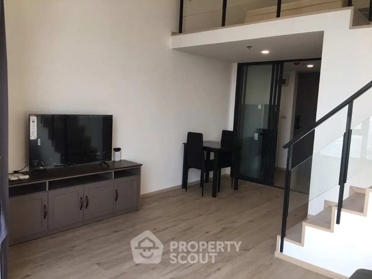 Modern duplex living room with sleek staircase and stylish furniture