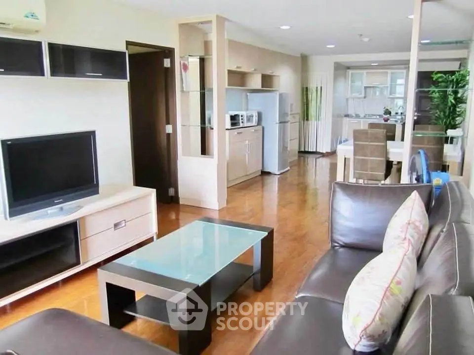 Spacious modern living room with open kitchen and stylish furnishings in a contemporary apartment.