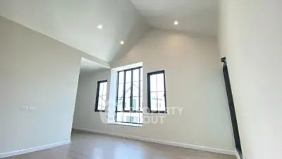 Spacious modern living room with high ceilings and large windows