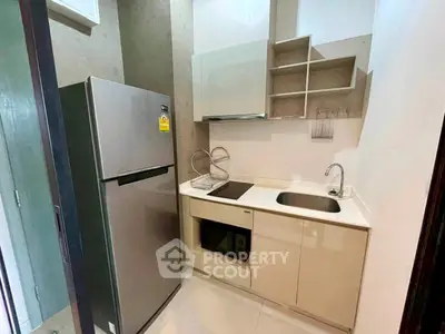 Modern compact kitchen with sleek appliances and minimalist design