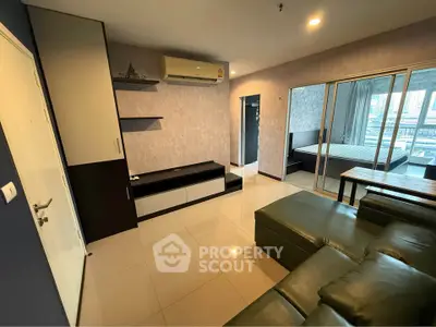 Modern living room with sleek design and open layout leading to bedroom