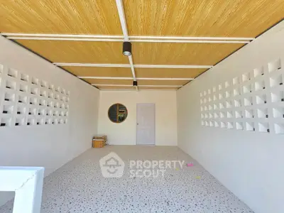 Spacious modern garage with unique ceiling design and ample storage space.