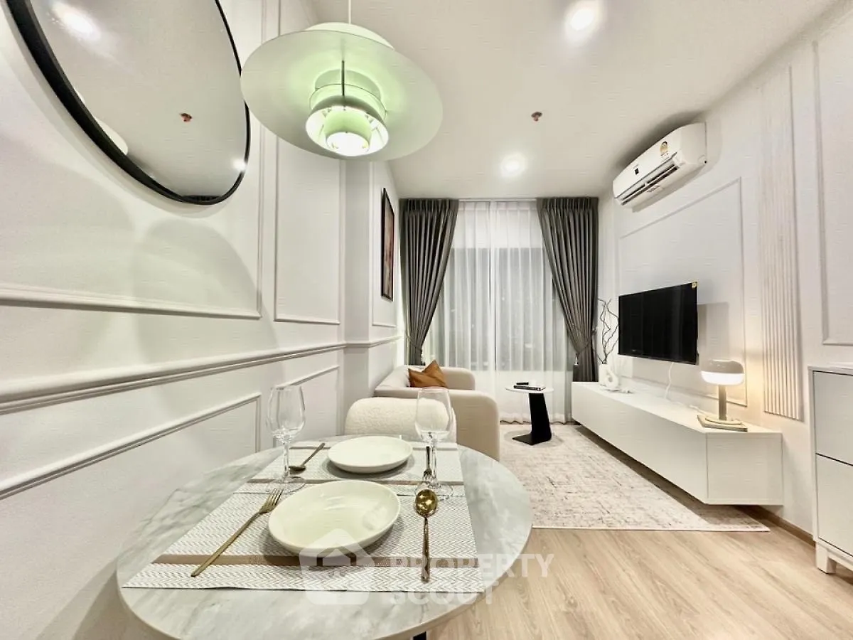 Modern living room with dining area, stylish decor, and natural light.
