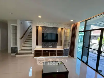 Spacious modern living room with sleek design and large windows for natural light.