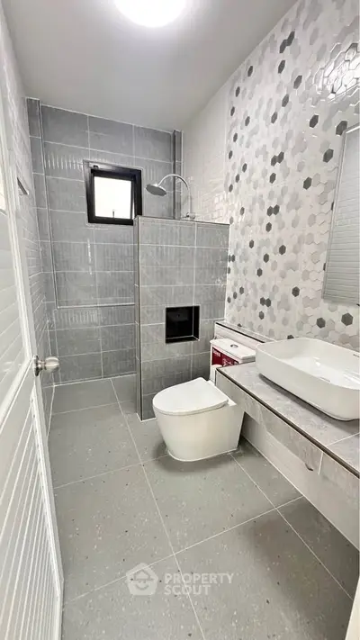 Modern bathroom with sleek gray tiles and stylish fixtures