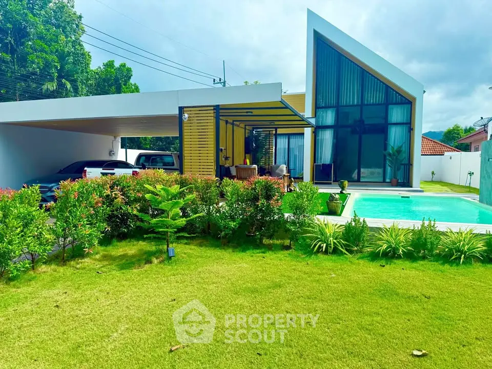 Modern architectural home with sleek design, lush garden, and inviting pool area.
