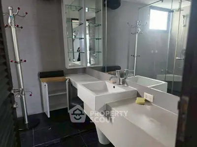 Modern bathroom with sleek fixtures and large mirror