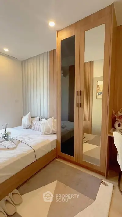 Cozy bedroom with modern wooden wardrobe and stylish decor