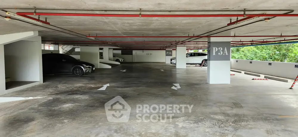 Spacious multi-level parking garage with ample lighting and clear directional signs.