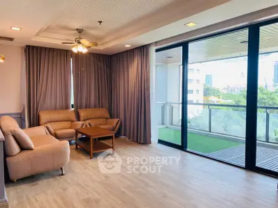 Spacious living room with large windows and balcony view in modern apartment.