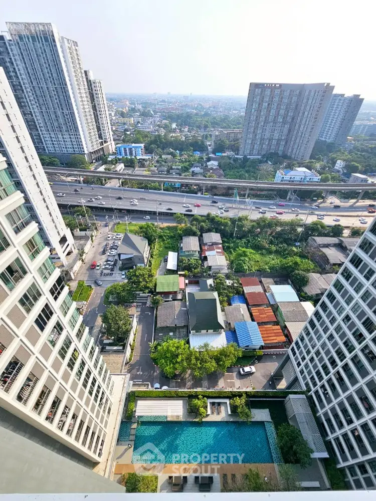 Stunning high-rise cityscape view with pool and modern buildings