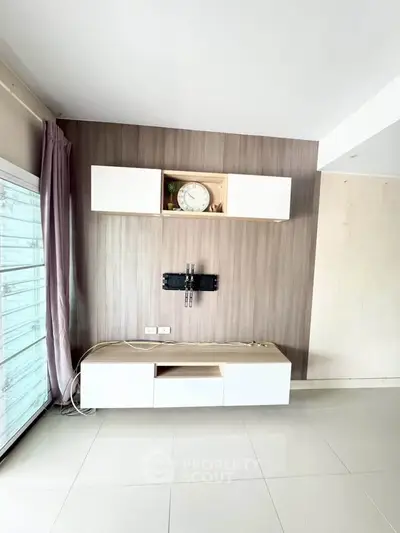 Modern living room with sleek wall-mounted TV unit and elegant decor
