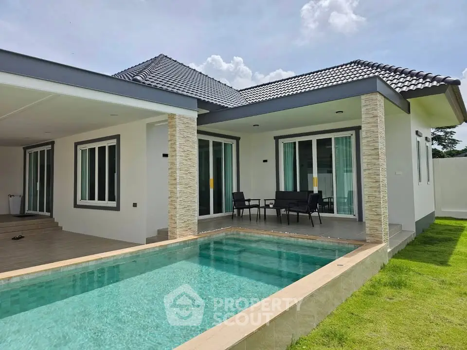 Modern single-story house with private pool and spacious patio, perfect for luxurious outdoor living.