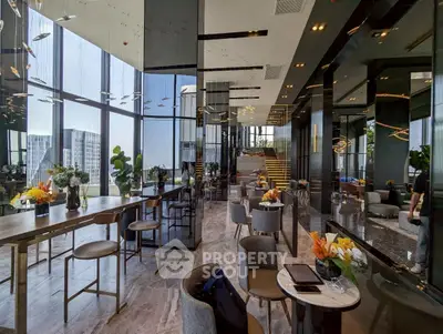 Luxurious modern living room with panoramic city views and elegant decor.