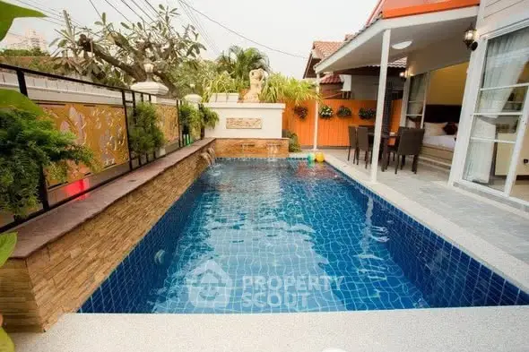 Luxurious private pool with modern patio in a serene residential setting.
