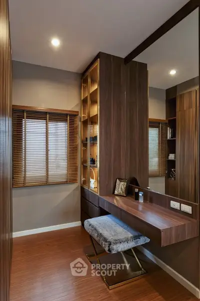 Stylish modern study area with wooden desk and shelving, perfect for productivity.