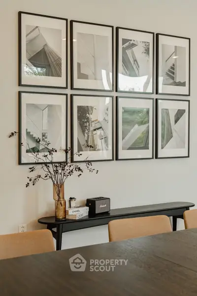 Elegant dining area with modern art and stylish decor, perfect for sophisticated gatherings.
