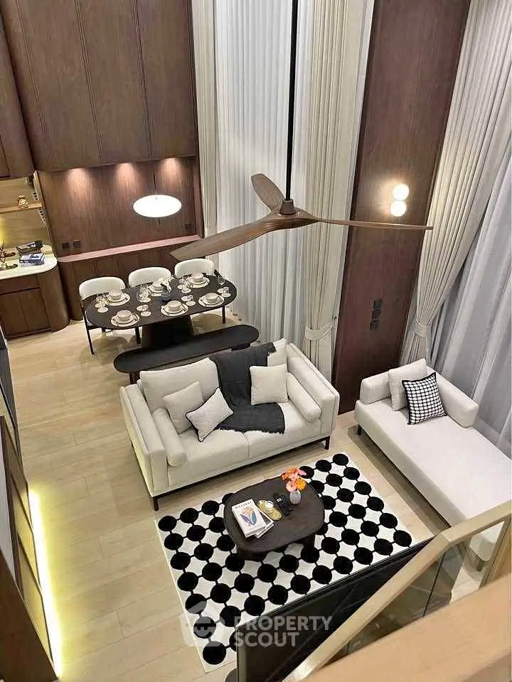 Luxurious modern living room with high ceilings and elegant dining area