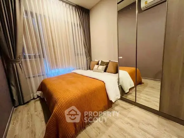 Cozy bedroom with mirrored wardrobe and elegant decor