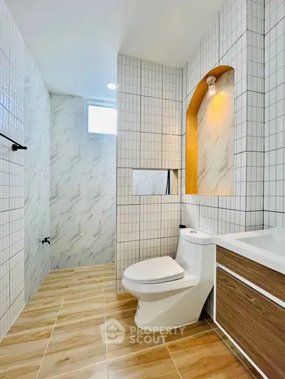 Modern bathroom with elegant tile design and natural light