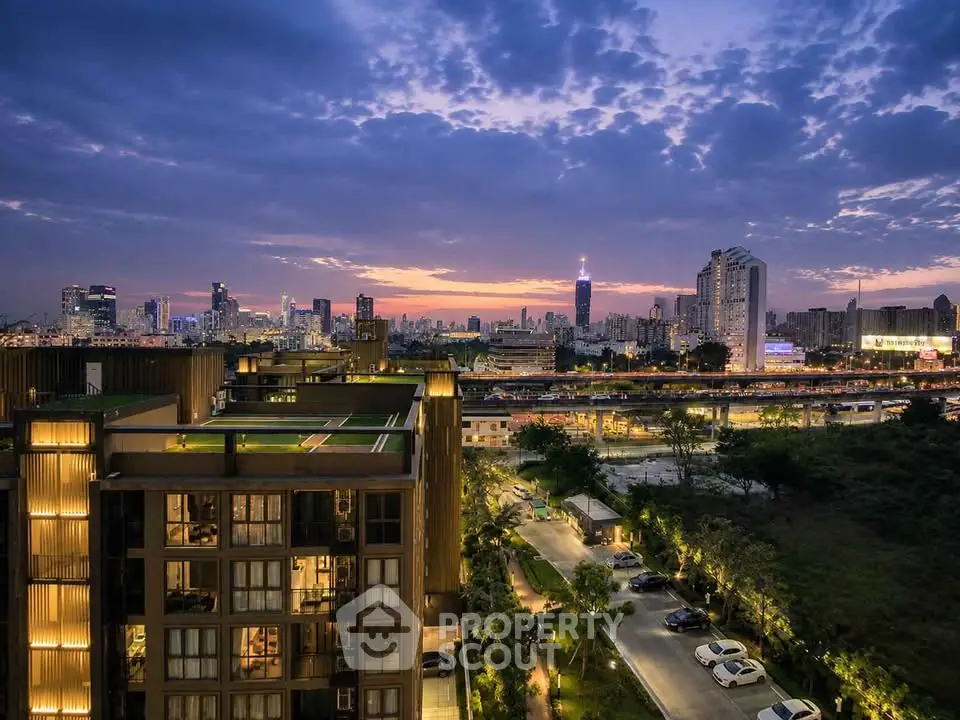 Stunning cityscape view from a modern apartment building at sunset, showcasing vibrant urban living.