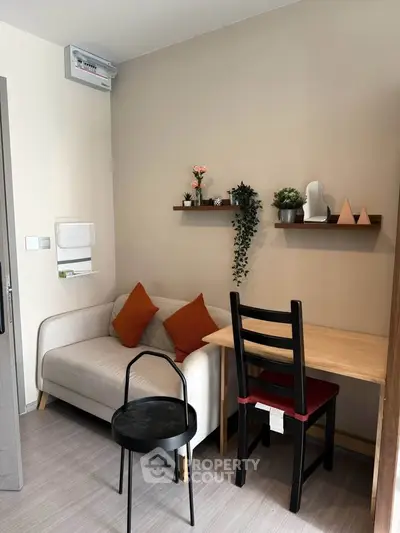 Cozy living room with modern decor and compact furniture, perfect for urban living.