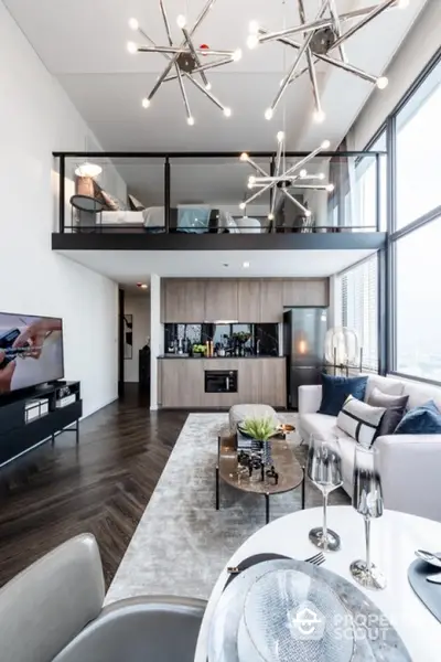 Luxurious modern loft with open kitchen and mezzanine bedroom, featuring stylish lighting and panoramic windows.