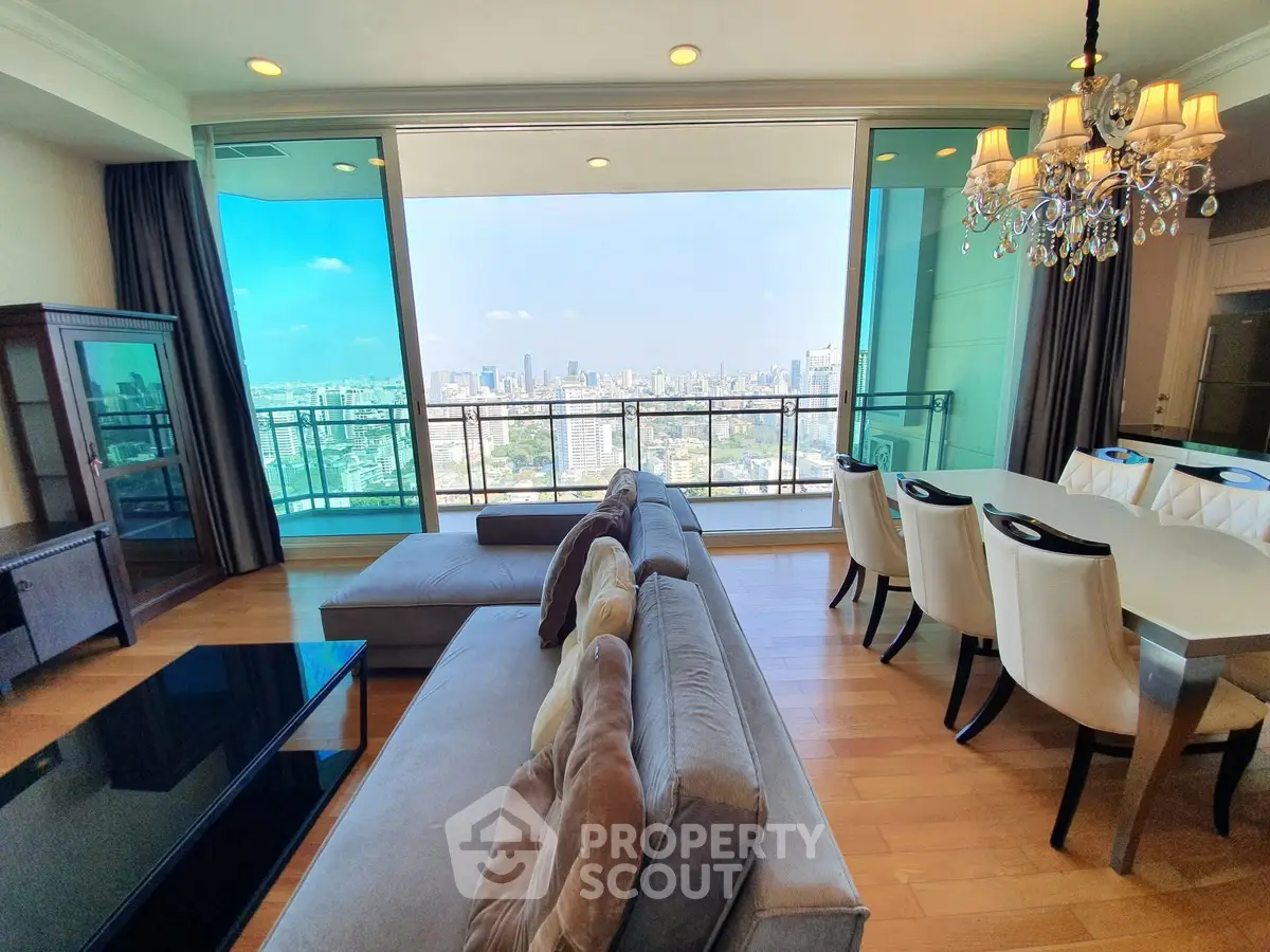 Luxurious living room with stunning city view and elegant dining area in high-rise apartment.