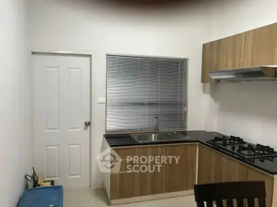 Modern kitchen with sleek cabinetry and gas stove in a compact layout