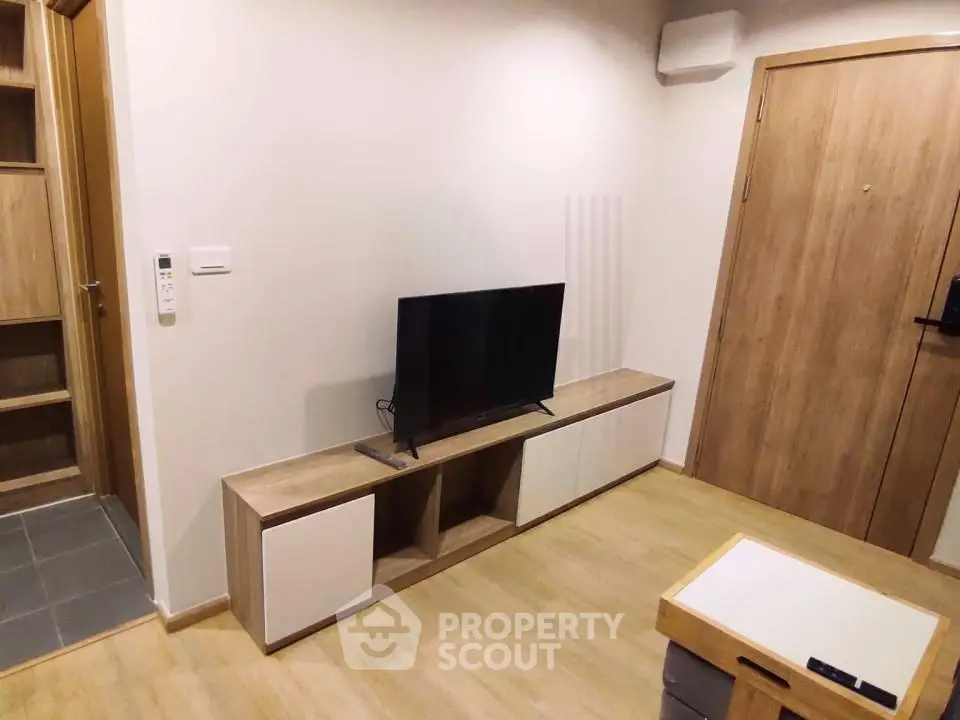 Modern living room with sleek TV stand and wooden flooring