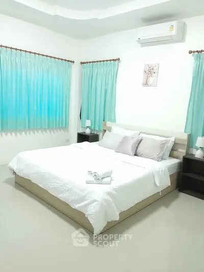 Spacious bedroom with modern decor and natural light