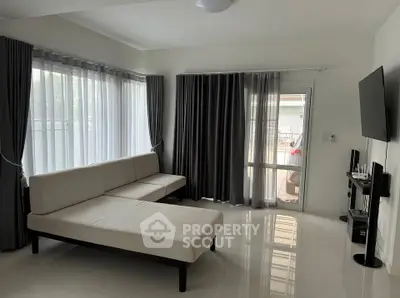 Spacious living room with modern furniture and large windows for natural light.