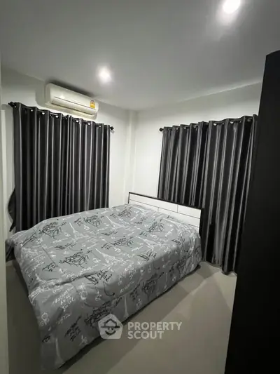 Cozy bedroom with modern decor and ample natural light, featuring stylish curtains and a comfortable bed.