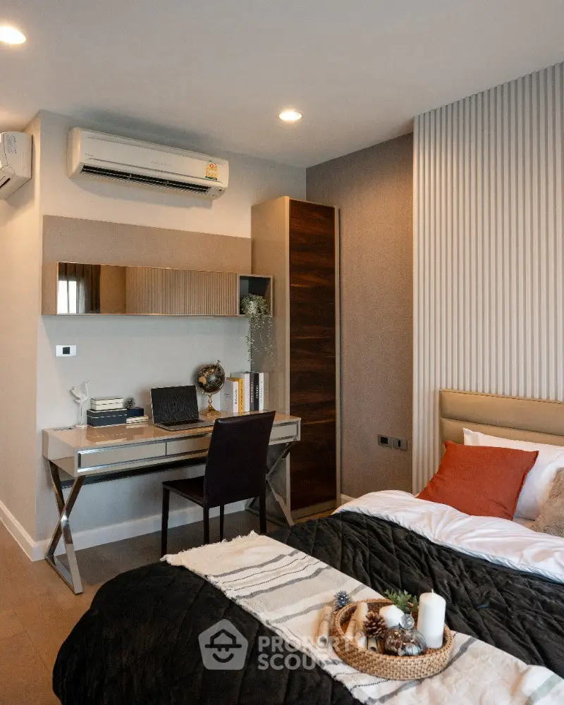 Modern bedroom with stylish decor and workspace, featuring a cozy bed and elegant desk setup.