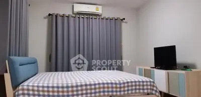 Cozy bedroom with modern furniture and air conditioning, perfect for relaxation.