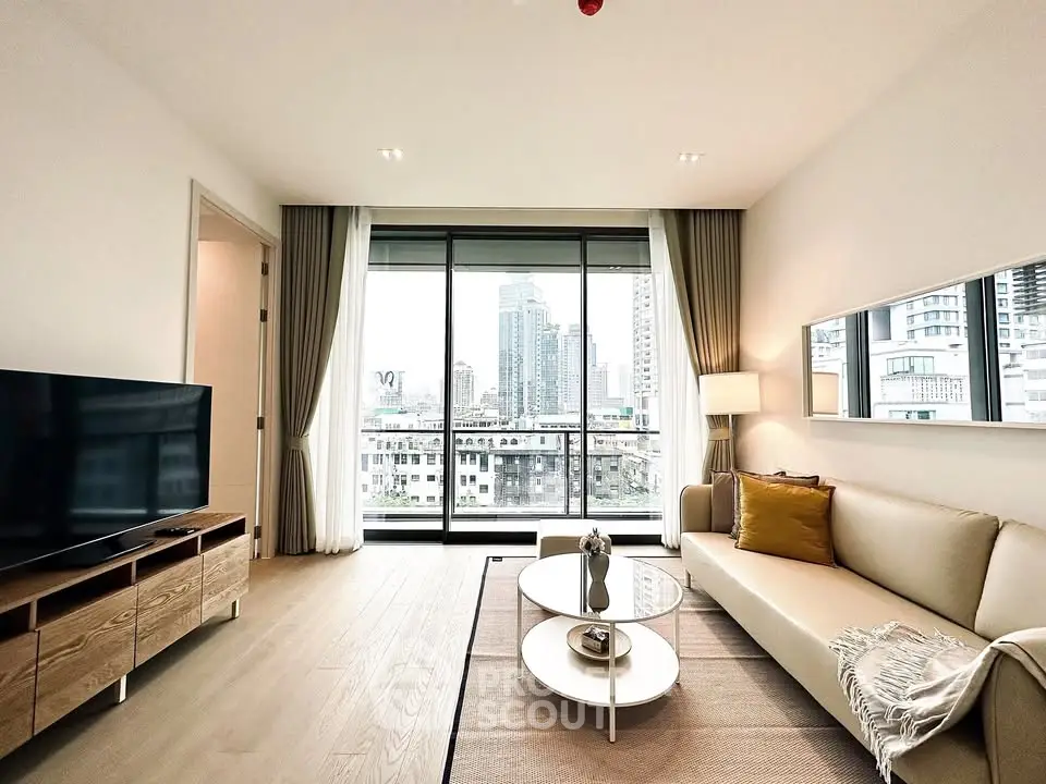 Modern living room with city view, featuring sleek furniture and large windows for natural light.
